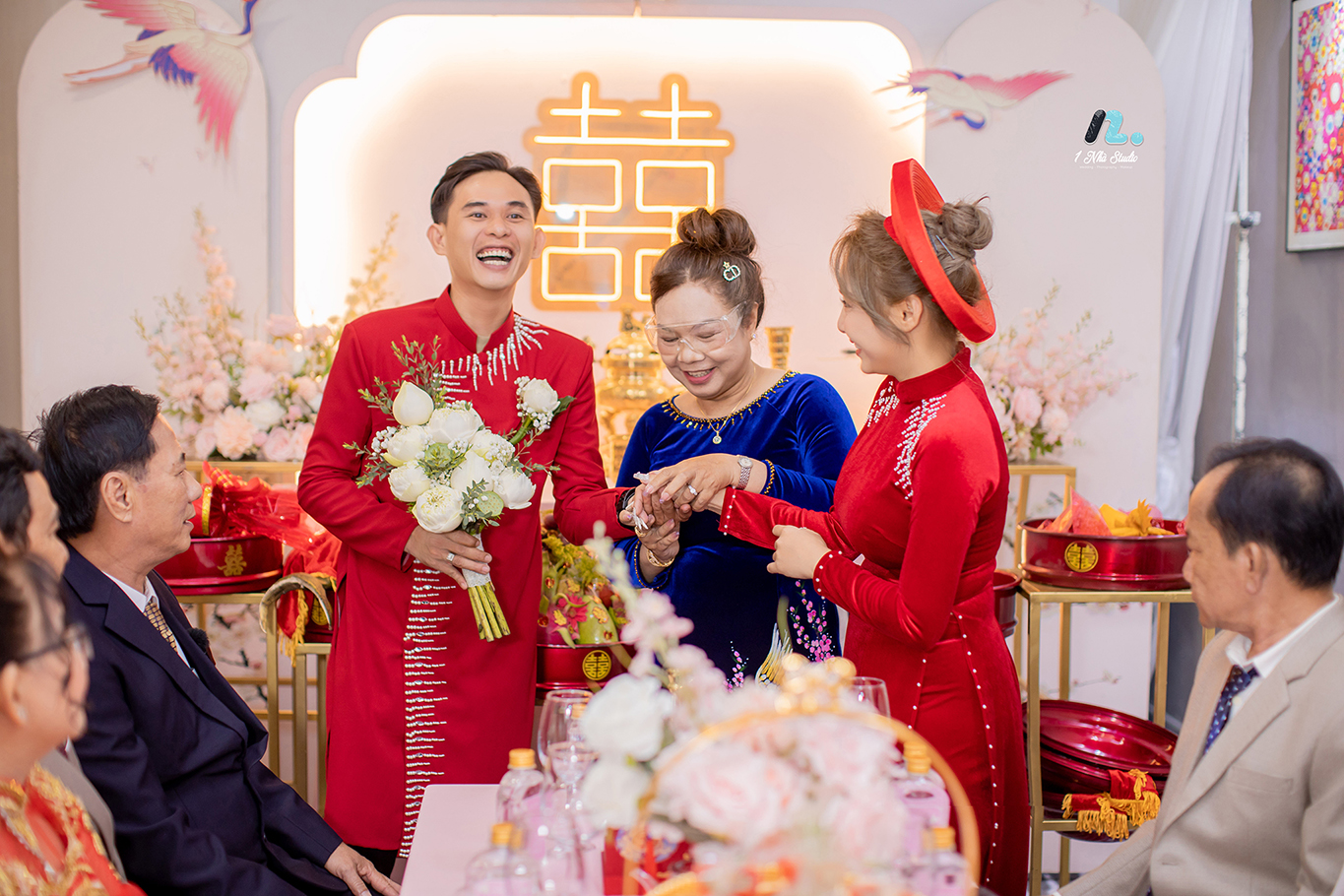 Chụp ảnh cưới cùng gia đình trong lễ gia tiên, mẹ đeo trang sức cho cô dâu bên cạnh hai họ